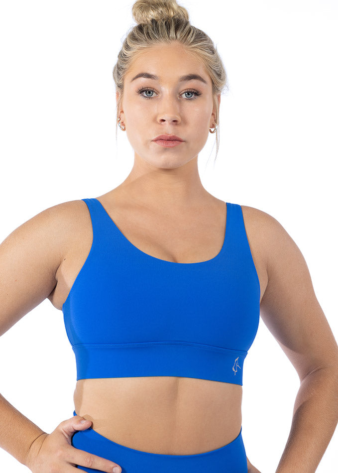 Front view of a blue sports bra for women featuring adjustable straps, thick under-band, and breathable VenaLux fabric.