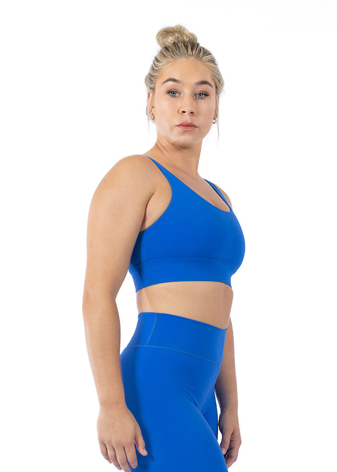 Right side view of a blue sports bra for women featuring adjustable straps, thick under-band, and breathable fabric.