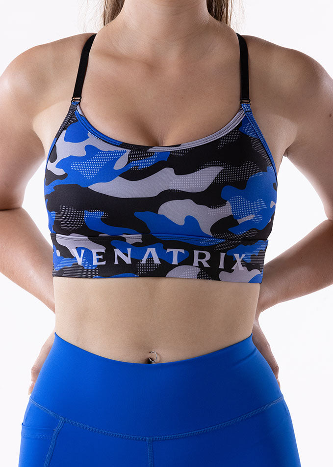 Blue camouflage padded push-up sports bra shown from front view with wide supportive band.