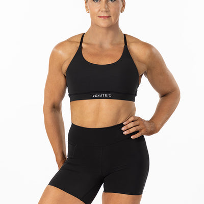Front view of a black padded sports bra with a sleek and supportive fit, perfect for running.